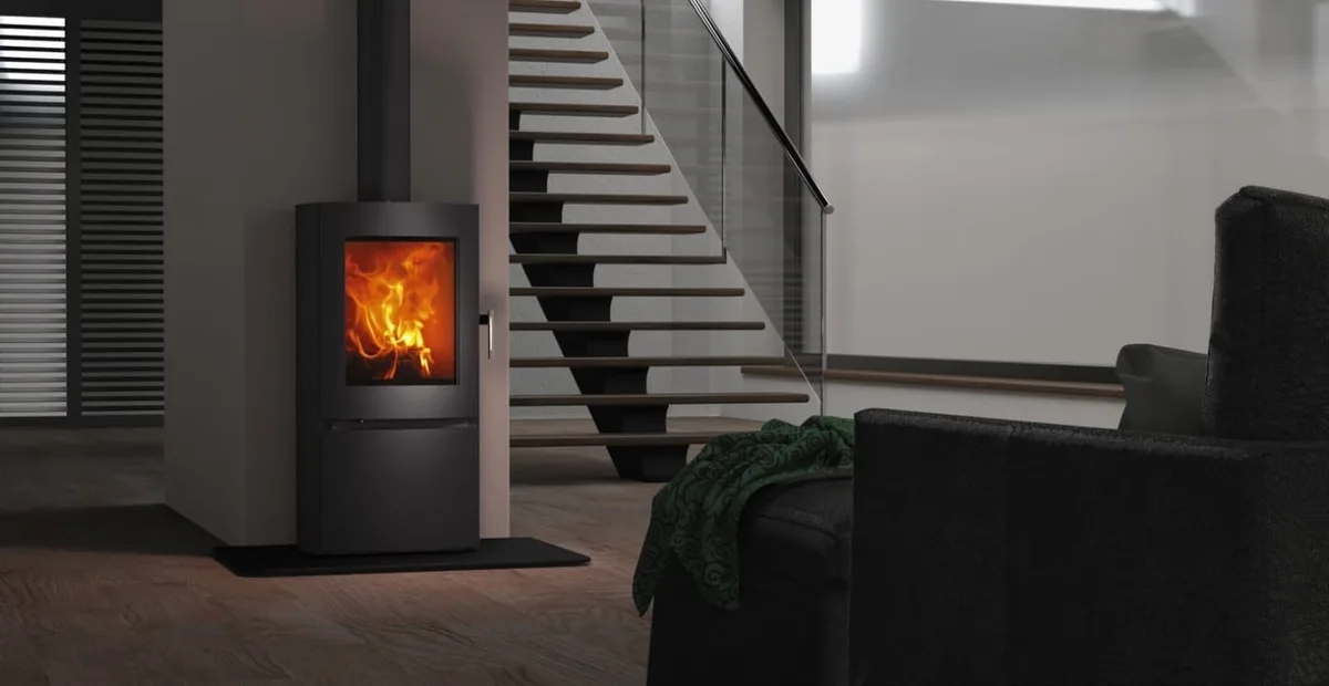 Freestanding slow-combustion fireplace burning in a contemporary interior