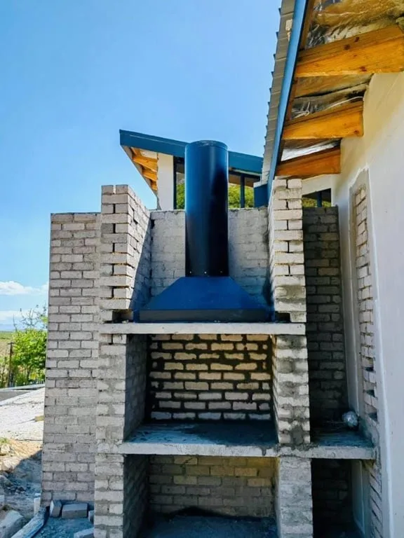 Built-in braai brick opening with canopy and flue in progress