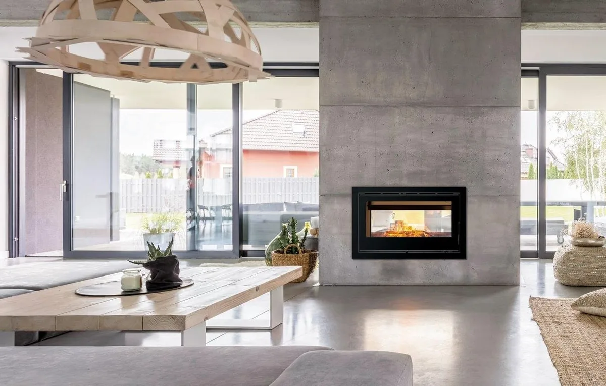 Double-sided slow-combustion fireplace connecting two living zones