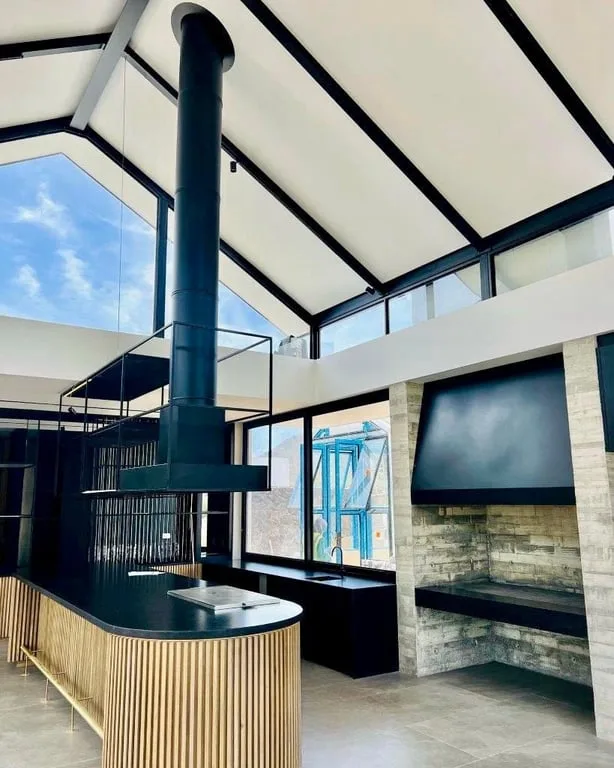 Built-in braai opening with canopy and flue installed in a covered entertainment area