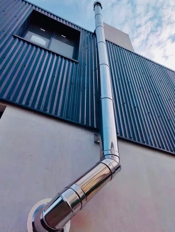 DINAK double wall stainless steel flue installed through a roof